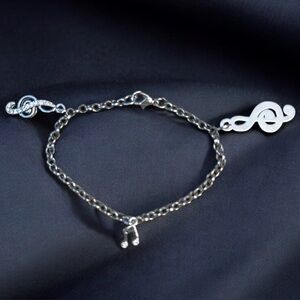 Silver tone musical notes charm bracelet